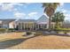Charming backyard with sunroom extension and covered porch on a bright, sunny day at 4608 Grovecrest Circle, North Myrtle Beach, SC 29582