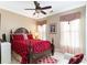 Comfortable bedroom with a ceiling fan, a large bed, and natural lighting at 4608 Grovecrest Circle, North Myrtle Beach, SC 29582