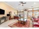 Spacious room with bright windows, TV, fireplace, desk and comfortable seating at 4608 Grovecrest Circle, North Myrtle Beach, SC 29582