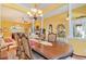 Open concept home featuring a formal dining room with large windows and stylish chandelier at 4608 Grovecrest Circle, North Myrtle Beach, SC 29582