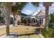 Charming brick home featuring a well-manicured lawn and palm trees in a desirable neighborhood at 4608 Grovecrest Circle, North Myrtle Beach, SC 29582