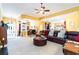 Spacious living room featuring a comfortable leather sofa and large windows with an open layout at 4608 Grovecrest Circle, North Myrtle Beach, SC 29582