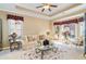 Elegant living room featuring large windows, ample seating, and tray ceilings at 4608 Grovecrest Circle, North Myrtle Beach, SC 29582