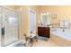 Bright bathroom featuring walk-in shower, soaking tub, vanity, and tile accents at 4608 Grovecrest Circle, North Myrtle Beach, SC 29582