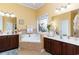 Luxurious bathroom with a soaking tub, dual vanities, and tile accents at 4608 Grovecrest Circle, North Myrtle Beach, SC 29582