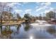Scenic view of the home situated by a tranquil pond with a fountain at 4608 Grovecrest Circle, North Myrtle Beach, SC 29582