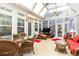 Inviting sun room with glass windows, comfortable seating, and lots of natural lighting at 4608 Grovecrest Circle, North Myrtle Beach, SC 29582