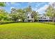 Spacious backyard with lush green grass and trees, creating a serene and private outdoor space at 476 Lakeshore Dr., Pawleys Island, SC 29585