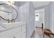 Bright bathroom features a modern vanity with granite countertop, a round mirror and white subway tile shower at 476 Lakeshore Dr., Pawleys Island, SC 29585