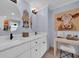 Bathroom with double sinks, white cabinets, marble countertops, and stylish decor at 476 Lakeshore Dr., Pawleys Island, SC 29585