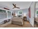 Bright bedroom features a ceiling fan, a comfortable bed, and decorative accents at 476 Lakeshore Dr., Pawleys Island, SC 29585