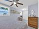 Charming bedroom with decor and a plush bed, featuring a vintage dresser and two well-lit windows at 476 Lakeshore Dr., Pawleys Island, SC 29585