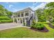 Two-story home with a staircase leading to the balconies and lush landscaping at 476 Lakeshore Dr., Pawleys Island, SC 29585
