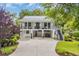 Charming two-story home with a metal roof, double balconies, and a spacious driveway at 476 Lakeshore Dr., Pawleys Island, SC 29585