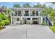 Two-story home featuring balconies and a covered parking area with a convenient golf cart at 476 Lakeshore Dr., Pawleys Island, SC 29585