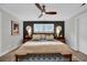 Stylish bedroom features a modern ceiling fan, large windows, and decorative lamps at 476 Lakeshore Dr., Pawleys Island, SC 29585