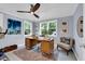 Bright, airy office space with two windows, ceiling fan, hardwood floors, neutral rug and comfortable seating at 476 Lakeshore Dr., Pawleys Island, SC 29585