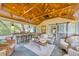 Inviting outdoor patio with wood ceiling and string lights, bar seating, and comfortable wicker furniture at 476 Lakeshore Dr., Pawleys Island, SC 29585