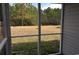 View of the spacious backyard with trees, seen from the screened porch at 4949 Southgate Pkwy., Myrtle Beach, SC 29579
