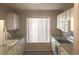 Bright kitchen with white cabinets, appliances, and a window overlooking the backyard at 4949 Southgate Pkwy., Myrtle Beach, SC 29579