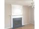 Living room showcasing a decorative fireplace with wood flooring and natural light from the windows at 4949 Southgate Pkwy., Myrtle Beach, SC 29579