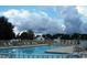 A bright community pool with multiple tables and lounge chairs for resident recreation at 4949 Southgate Pkwy., Myrtle Beach, SC 29579