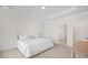 Spacious bedroom with ensuite bathroom, carpeted floors, and a queen-size bed with soft white bedding at 503 Rose Fountain Dr., Myrtle Beach, SC 29579