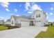 Charming two-story home features a three-car garage, stone accents, manicured lawn, and a concrete driveway at 503 Rose Fountain Dr., Myrtle Beach, SC 29579