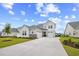Beautiful two-story home with a large concrete driveway, three-car garage, and manicured lawn at 503 Rose Fountain Dr., Myrtle Beach, SC 29579