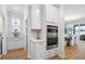 This kitchen features built-in stainless steel ovens, white cabinets, and marble backsplash at 503 Rose Fountain Dr., Myrtle Beach, SC 29579
