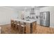 Well-lit kitchen boasts a large island, stainless steel appliances, white cabinetry, and marble backsplash at 503 Rose Fountain Dr., Myrtle Beach, SC 29579