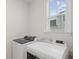 Bright laundry room featuring a window, washer, and dryer at 503 Rose Fountain Dr., Myrtle Beach, SC 29579