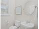 Powder room featuring a round mirror, pedestal sink, and nearby toilet at 503 Rose Fountain Dr., Myrtle Beach, SC 29579