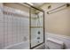 Cozy bathroom featuring a tub with tiled walls and a glass shower door at 5905 S Kings Hwy. # 1717, Myrtle Beach, SC 29575