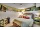 Bedroom features a wicker bedframe, decorative shelving, and green walls for a warm, inviting space at 5905 S Kings Hwy. # 1717, Myrtle Beach, SC 29575