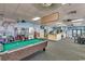 Spacious game room with a pool table, arcade games, and seating area offers a fun and social environment at 5905 S Kings Hwy. # 1717, Myrtle Beach, SC 29575