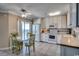 Bright kitchen with white appliances, a dining area, and an ocean view from the sliding glass door at 5905 S Kings Hwy. # 1717, Myrtle Beach, SC 29575