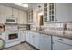 Bright kitchen features white cabinetry, modern appliances, tile backsplash, and ample counter space at 5905 S Kings Hwy. # 1717, Myrtle Beach, SC 29575