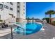 Enjoy the outdoor pool with seating and mature landscaping at 5905 S Kings Hwy. # 1717, Myrtle Beach, SC 29575