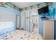 Bright blue bedroom featuring a TV, wicker furniture, and an ocean view mural at 6001-1501 S Kings Hwy., Myrtle Beach, SC 29575