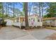 Charming single-story home with a cozy porch and lush landscaping surrounded by mature trees at 6001-1501 S Kings Hwy., Myrtle Beach, SC 29575