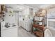 A charming kitchen with white appliances, decorative wallpaper, and a rustic shelving unit at 6001-1501 S Kings Hwy., Myrtle Beach, SC 29575
