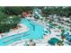 Aerial view of a lively waterpark showcasing a lazy river and thrilling waterslides amidst lush scenery at 6001-1501 S Kings Hwy., Myrtle Beach, SC 29575