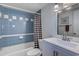 Bathroom featuring blue tiled walls, a bathtub with a shower, and a vanity with a mirror at 601 Mitchell Dr. # 806, Myrtle Beach, SC 29577