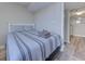 Cozy bedroom featuring a comfortable bed with striped bedding and access to ensuite bathroom at 601 Mitchell Dr. # 806, Myrtle Beach, SC 29577