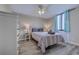 Charming bedroom with a ceiling fan, wooden furniture, and natural light from the window at 601 Mitchell Dr. # 806, Myrtle Beach, SC 29577