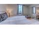 Bright bedroom featuring a large window with curtains and a sliding closet door at 601 Mitchell Dr. # 806, Myrtle Beach, SC 29577