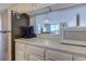 Kitchen counter featuring appliances, white cabinets, and a view to living room at 601 Mitchell Dr. # 806, Myrtle Beach, SC 29577