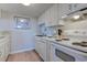 Bright kitchen featuring white cabinets, modern appliances, and laminate floors at 601 Mitchell Dr. # 806, Myrtle Beach, SC 29577