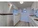 Kitchen featuring a refrigerator, white cabinets, and stainless steel sink at 601 Mitchell Dr. # 806, Myrtle Beach, SC 29577